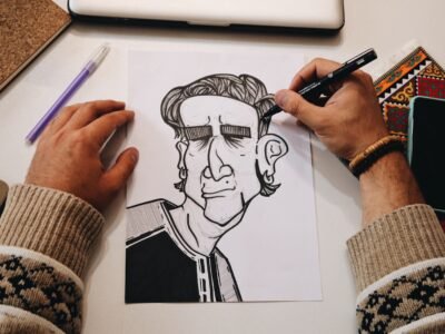 Designer drawing character studies on paper