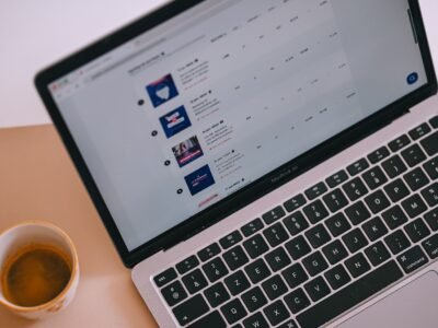 Drafting copy at a laptop with coffee